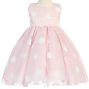 A pink dress with white polka dots on it